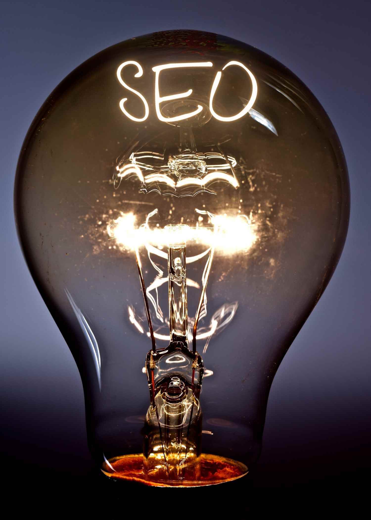 The word SEO lit up in a turned on lighted up lightglobe